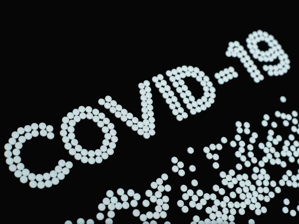 covid 19 spelled out in pills