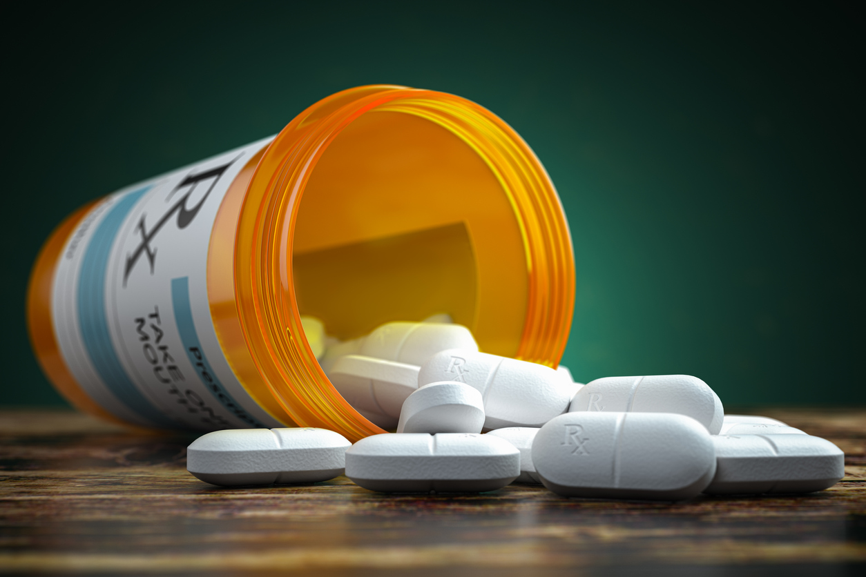 pills in bottle spilling over - opioids example - potentially fatal drug withdrawal