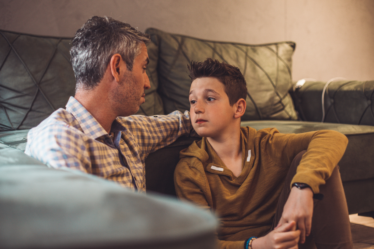 Father sitting down with young son to Explain the Detox Process