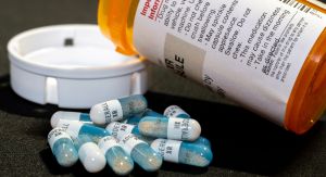 Adderall Pills beside a prescription vile